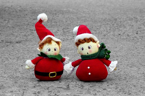 zwei Weihnachtsmannfiguren im Sand