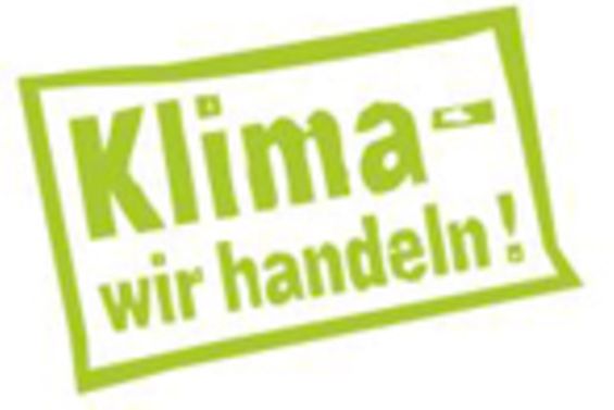 Schriftzug wie ein Stempel in grüner Farbe: Klima - wir handeln!